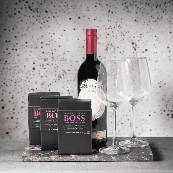 "Triple the Chocolate" Wine Gift Set with Bottle Of Wine, Boss White Chocolate Box, Boss Medium Dark Chocolate Box, Boss Extra Dark Chocolate Box, Marble Serving Board, and 2 Wine Glasses.