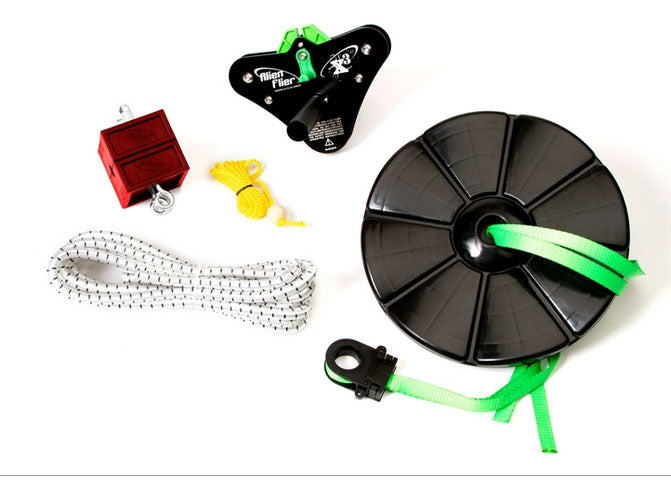 Black and green zip line trolley, black disc seat with green strap, white rope, yellow tow rope, and red stop block.