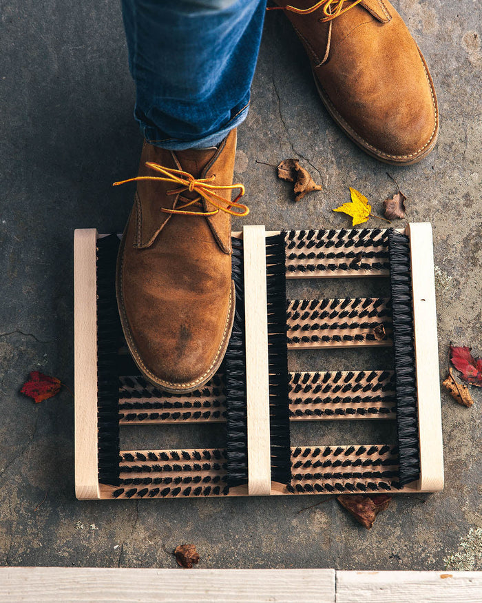 Farmhouse Beechwood Boot Scraper — boots beside the scraper; Farmhouse Pottery