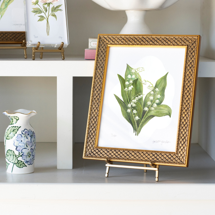 Lily of the Valley Archival Art Print — Trellis-framed print on a separate display stand among shelves; Susan Gordon