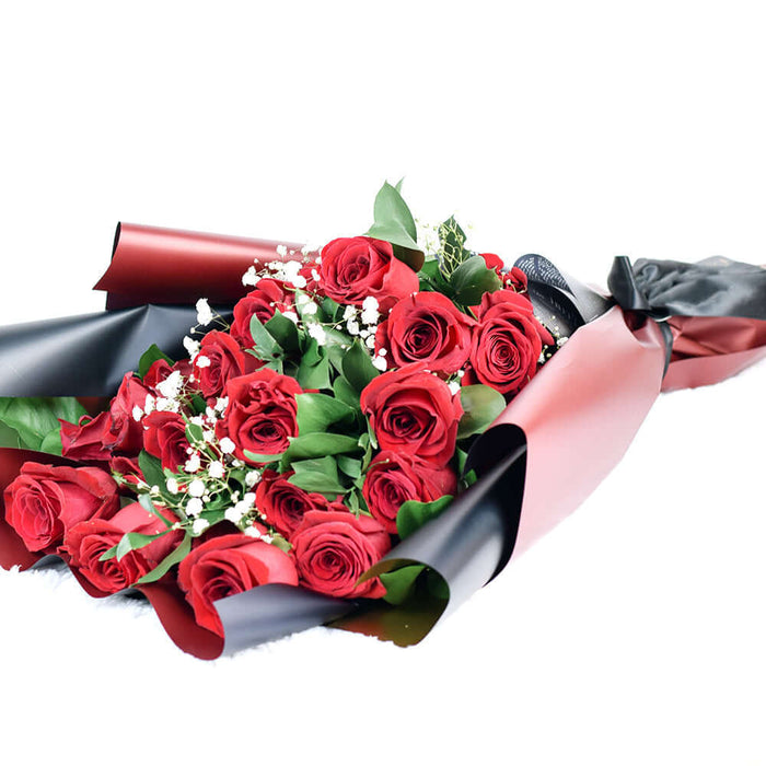 This bouquet includes a selection of deep red roses, baby's breath, and ruscus gathered in floral wrap with designer ribbon.