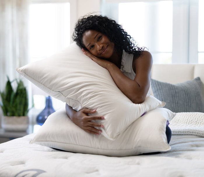 PranaSleep Halo Down Pillow, woman holding 2 pillows