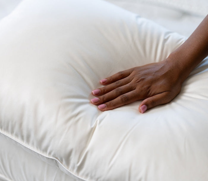 PranaSleep Halo Down Pillow by PranaSleep, woman pressing on pillow