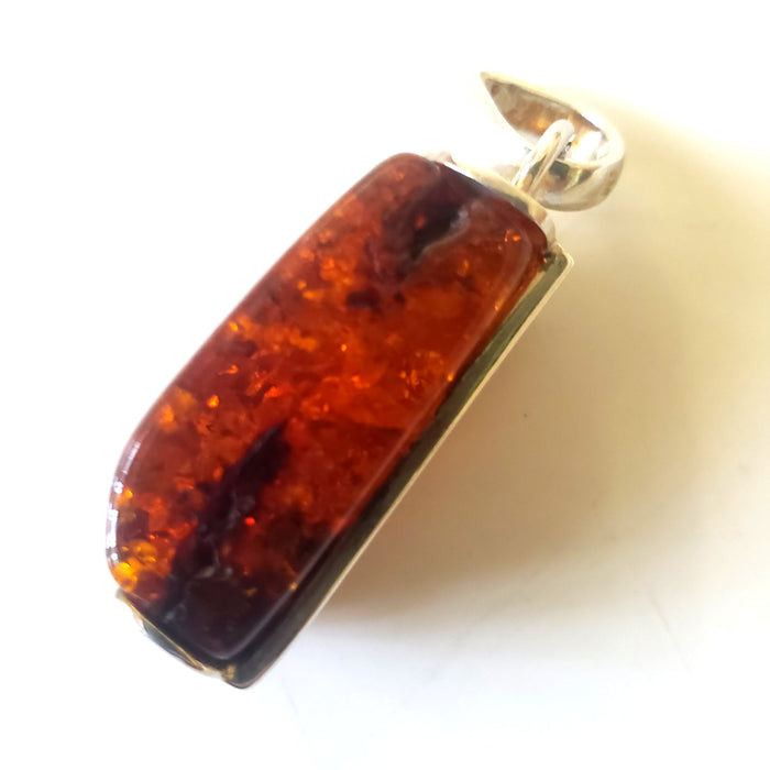 Rectangular cognac amber pendant in sterling silver frame side