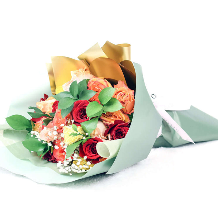Bouquet with red, orange and yellow roses. Baby's breath and ruscus