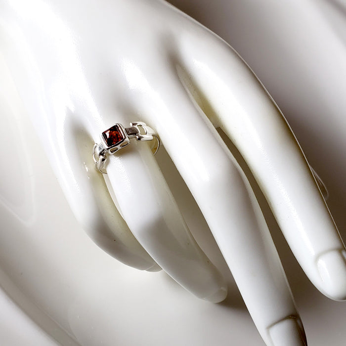 the sterling silver ring with square amber on a finger
