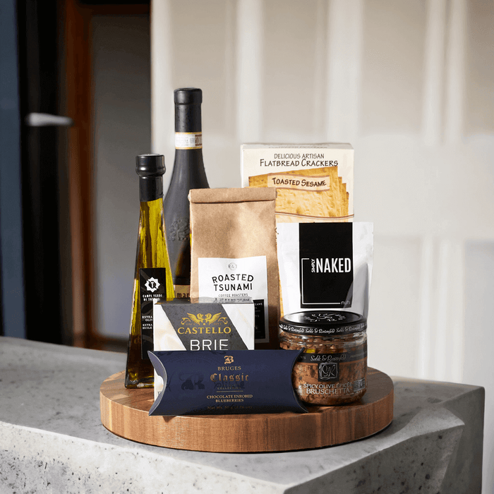 The Grand Gourmet Wine Gift Basket from Monthly Sommelier is a special gift for someone special, loaded with deliciously luxurious snacks and delicacies. With gourmet brie cheese and crackers, spicy olive bruschetta, rich olive oil, sea salt almonds, delicious chocolate covered blueberries, and coffee, this gift basket is a delightful treat.