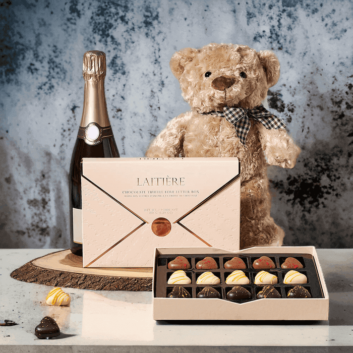 This gift features a bottle of sparkling wine, a love letter box of chocolate truffles, a plush teddy bear toy, and a live-edge serving board for presentation. You may personalize this gift by adding on your choice of wine, beer, gourmet snacks, and more from our custom options.